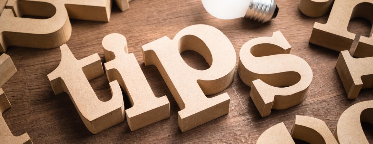 The word 'tips' written out with wooden block letters.