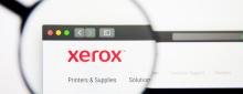 Magnifying glass hovering over Xerox website.